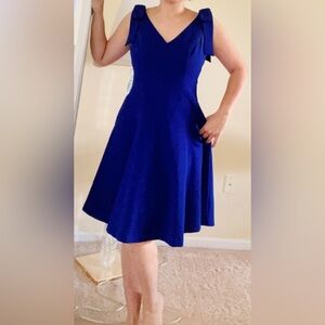 Beautiful blue dress with pockets on sides and large bows on shoulders size 4